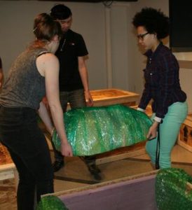 Students help move Jeff Hesser's Gallery exhibition into place.