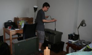 Max Crandall sets up his room.