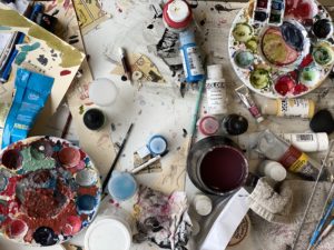 Image paints and art supplies in a studio setting