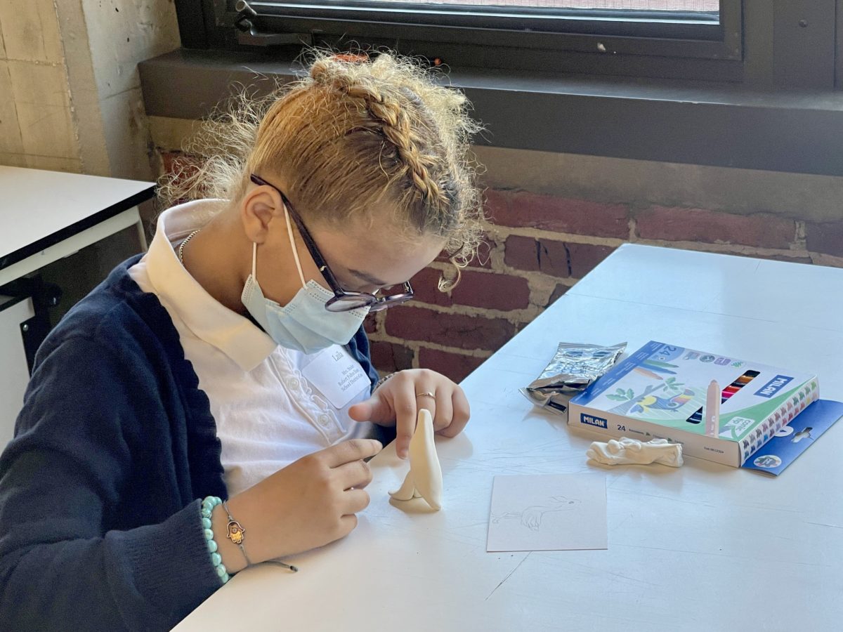 A Fulton Elementary 5th-grader works on her character model. 