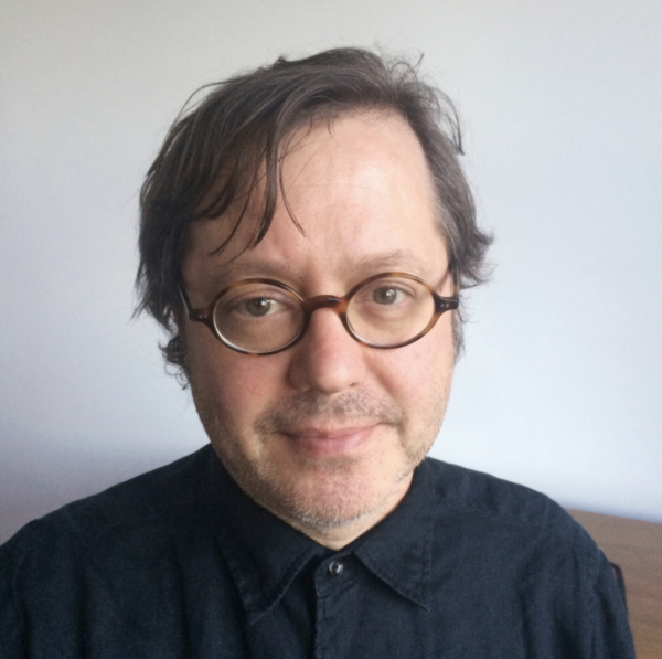 headshot of brown haired man wearing round glasses. Prof. Eric Weeks