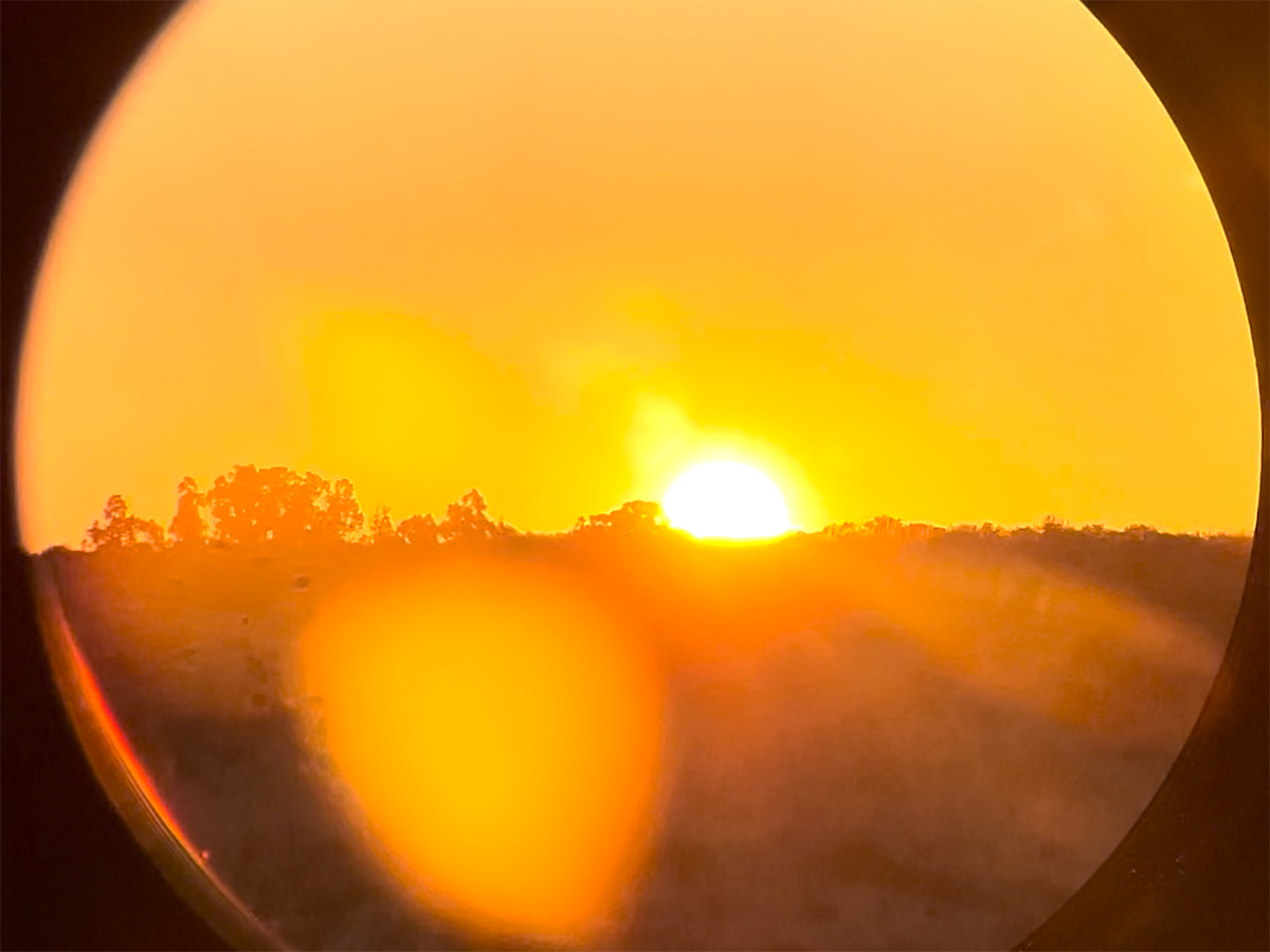 sunrise or sunset through round eyeglass frames. 