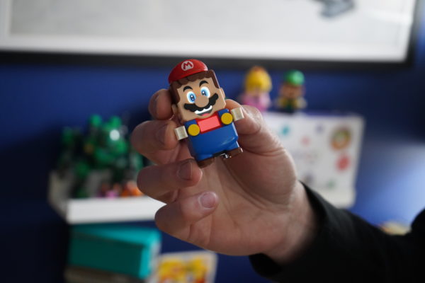 Hand holding a Super Mario interactive toy. 