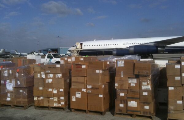 Cargo boxes piled in front of jet