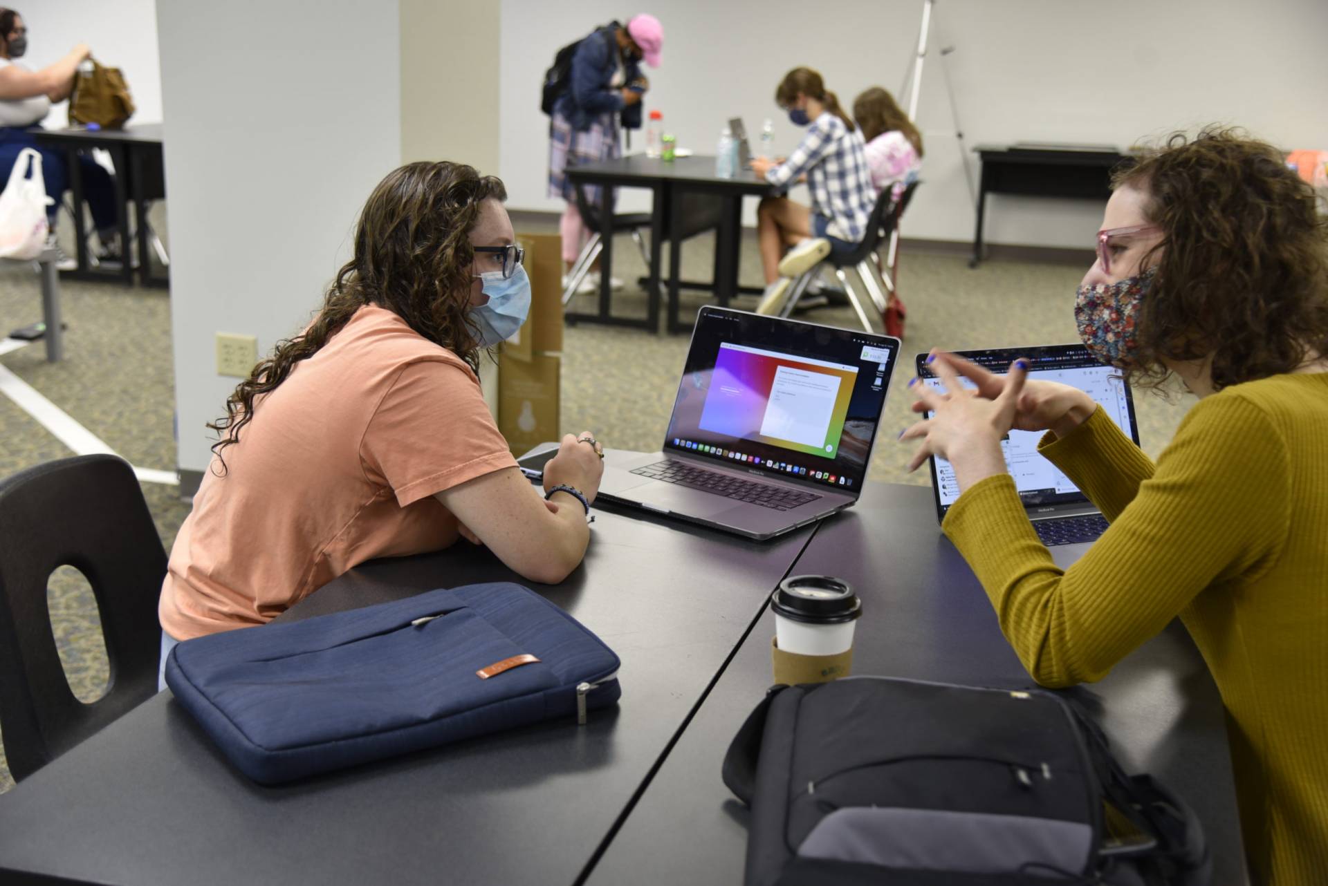 Information Technology's Alex Leonhart, right, does some troubleshooting with a new student. 
